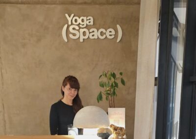 Yoga Mida logging participants for one of her group classes at Yoga Space.